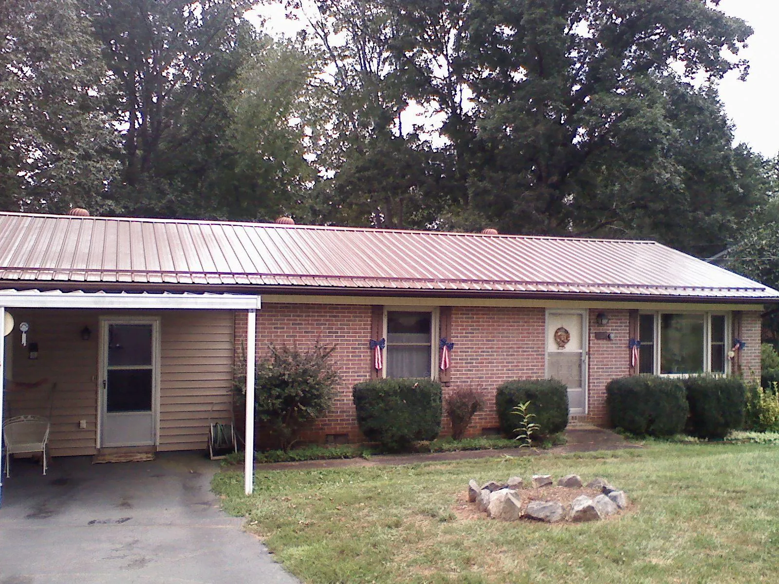 Bronze metal roof and carport on a brick ranch home — Roof Repair work by our crew in Potrero